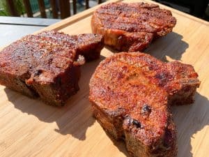 thick smoked pork chops on a cutting board