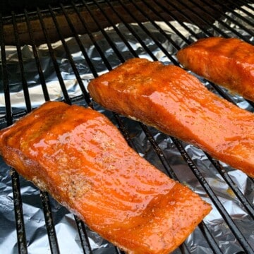 smoked salmon fillets on the grates of a traeger pellet grill