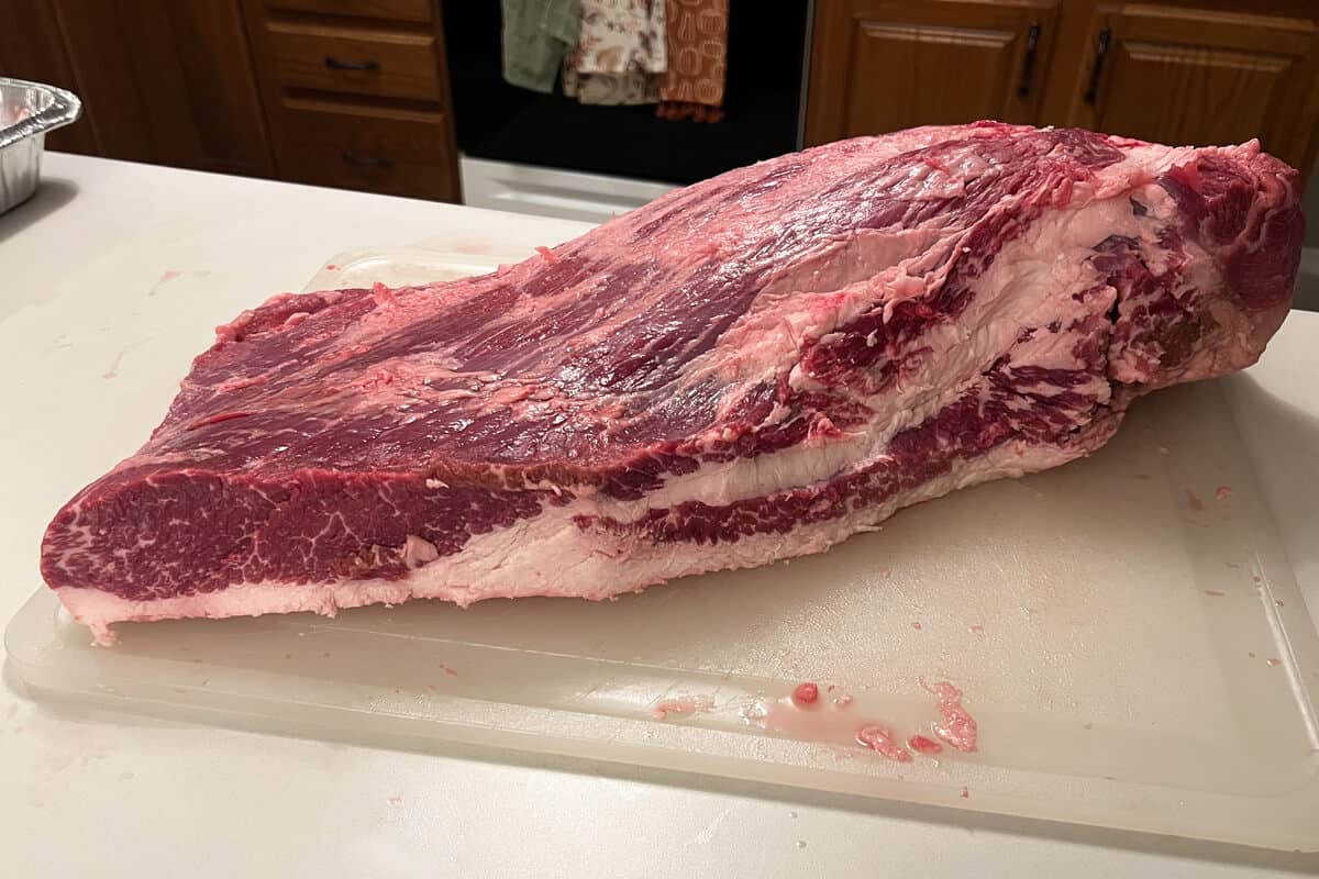 raw full packer beef brisket on a cutting board