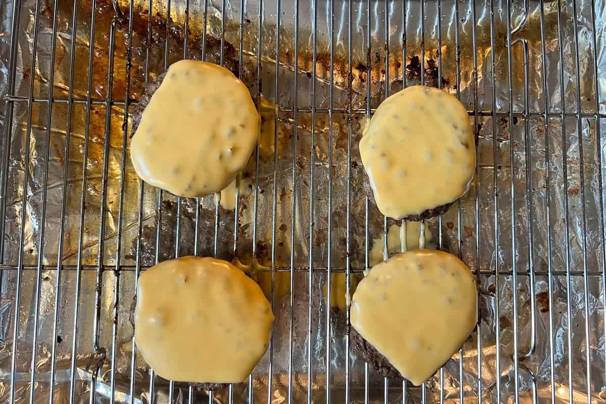 Cheeseburgers on a wire baking rack