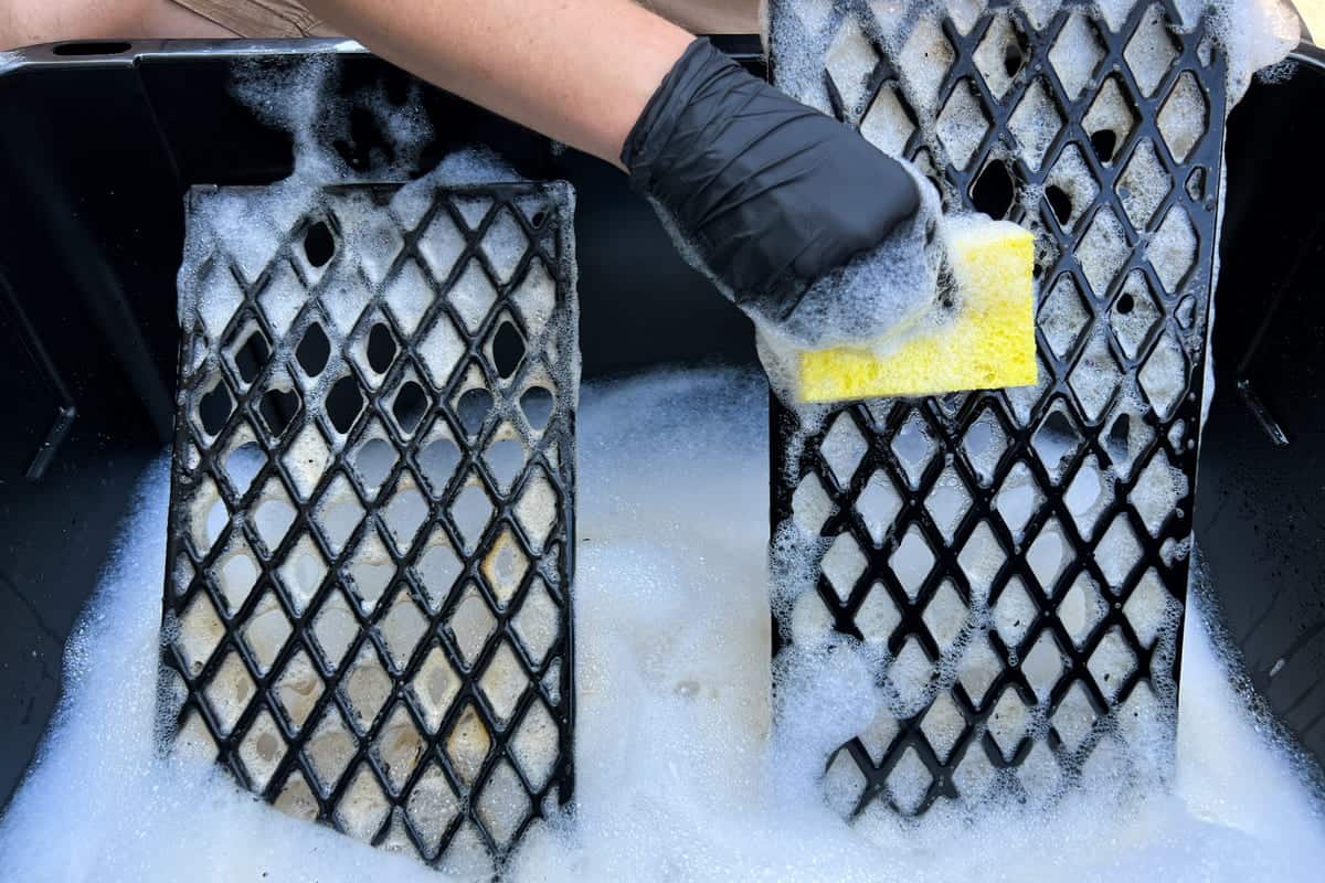 scrubbing the grates with a kitchen sponge and mild dish soap