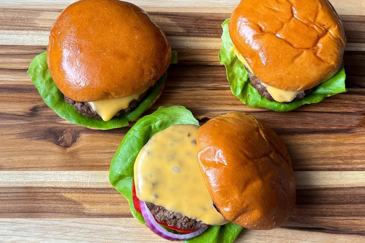 Cheeseburgers on a wooden cutting board
