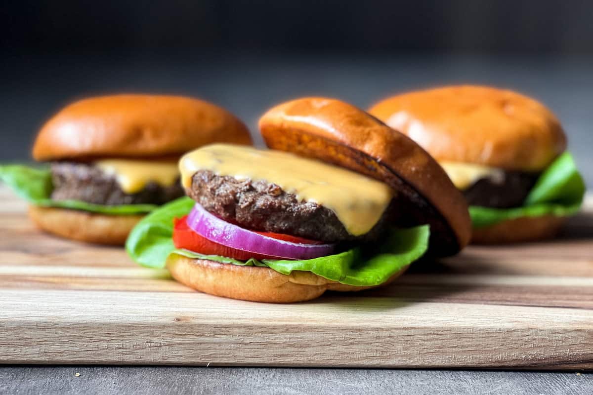 Cheeseburgers on a wooden cutting board