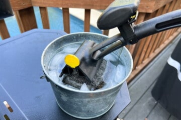 BBQ daddy grill brush with head submerged in ice water bucket