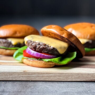 Cheeseburgers on a wooden cutting board