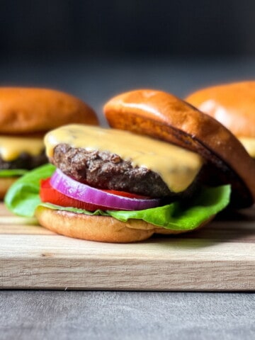 Cheeseburgers on a wooden cutting board