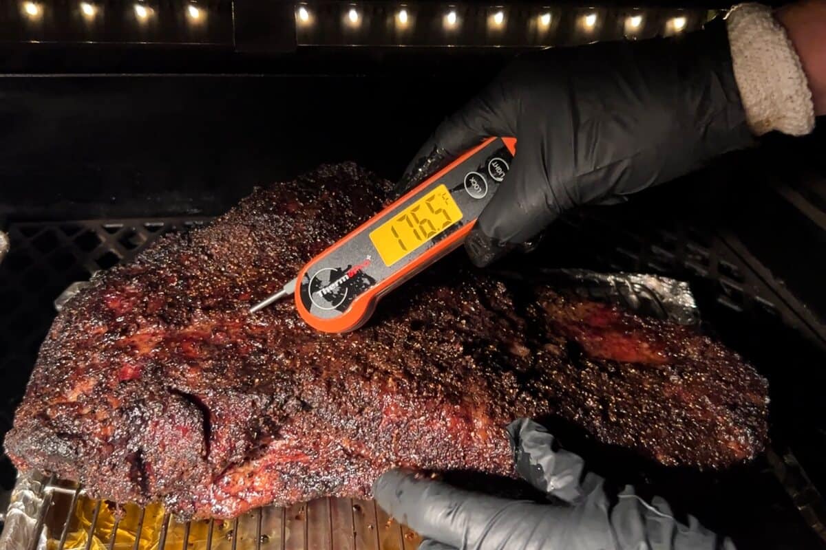 an instant read thermometer in the brisket measuring 176.5 degrees F 