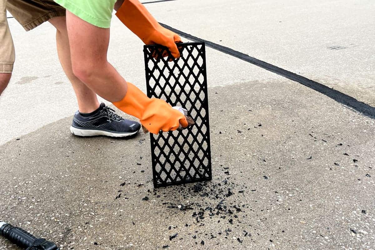 scrubbing charred bits off the grill grates