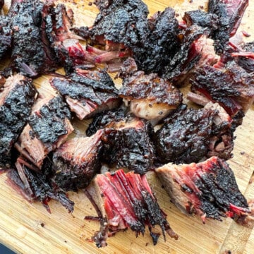 burnt ends from beef brisket cut into chunks on a cutting board