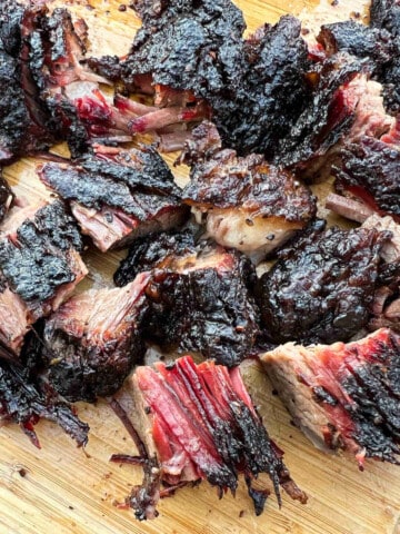burnt ends from beef brisket cut into chunks on a cutting board