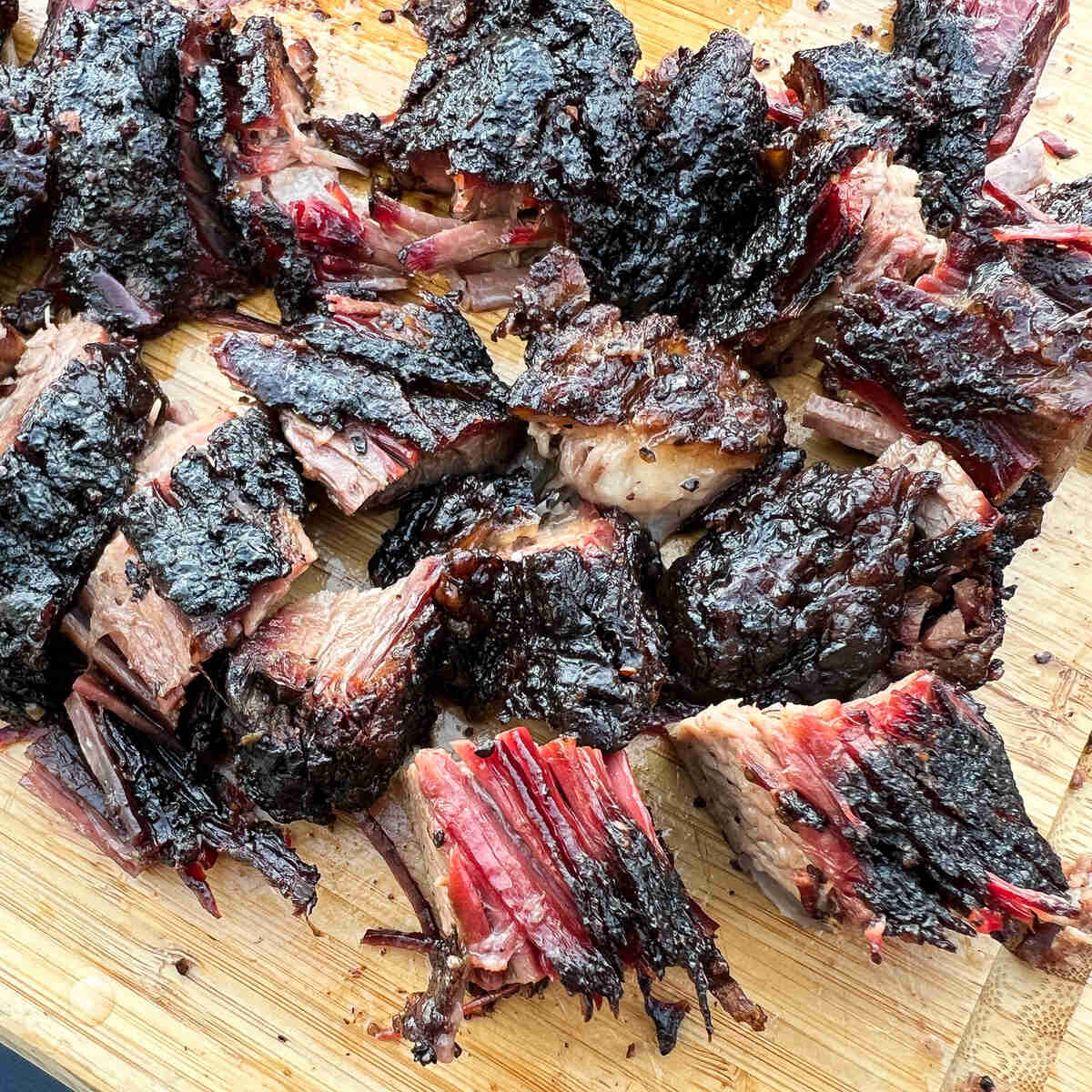 burnt ends from beef brisket cut into chunks on a cutting board