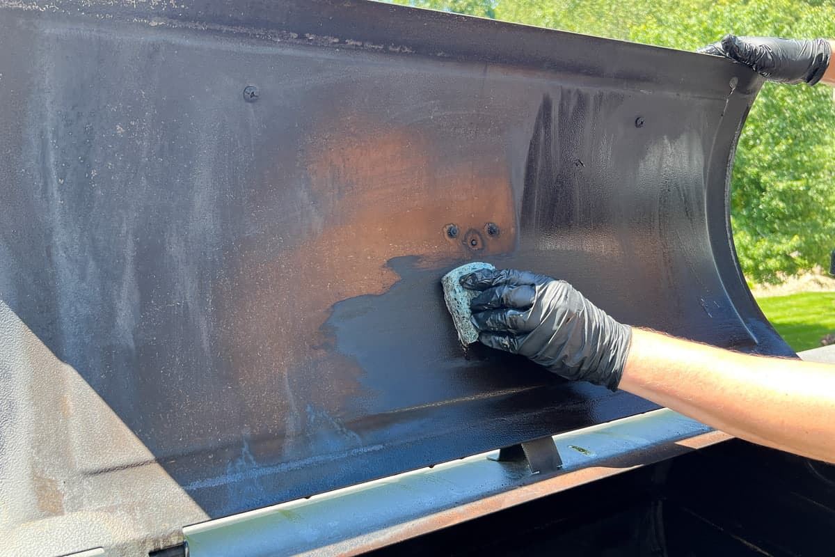 wiping degreaser on the inside of the lid