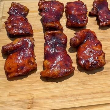 smoked boneless skinless chicken thighs on a cutting board