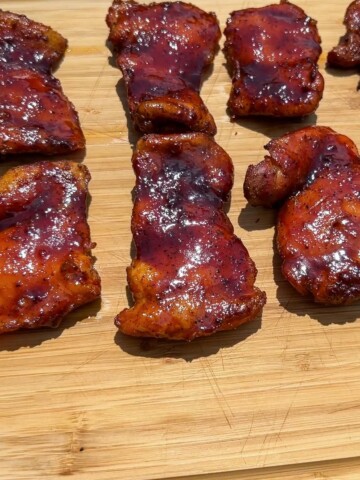 smoked boneless skinless chicken thighs on a cutting board