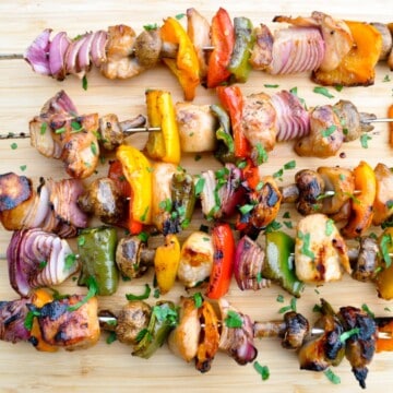 Chicken kabobs on a wooden cutting board