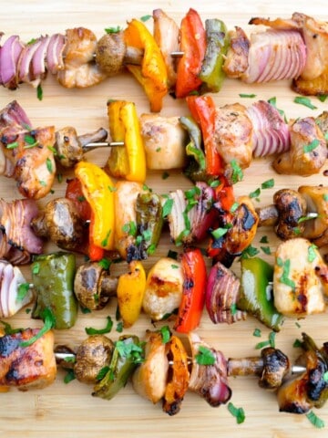 Chicken kabobs on a wooden cutting board