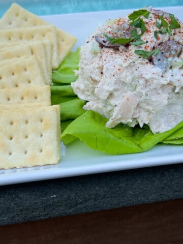 Smoked chicken salad on a lettuce leaf with crackers