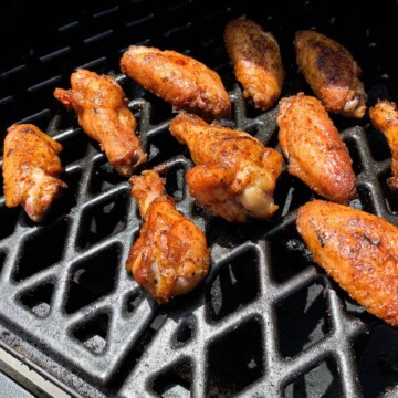 smoked chicken wings on the grates of a pit boss pellet grill