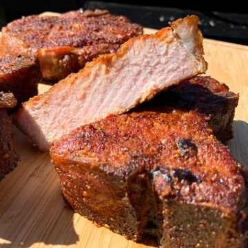 Electric Smoker Pork Chops sliced on a cutting board