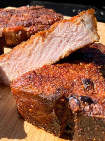 Electric Smoker Pork Chops sliced on a cutting board