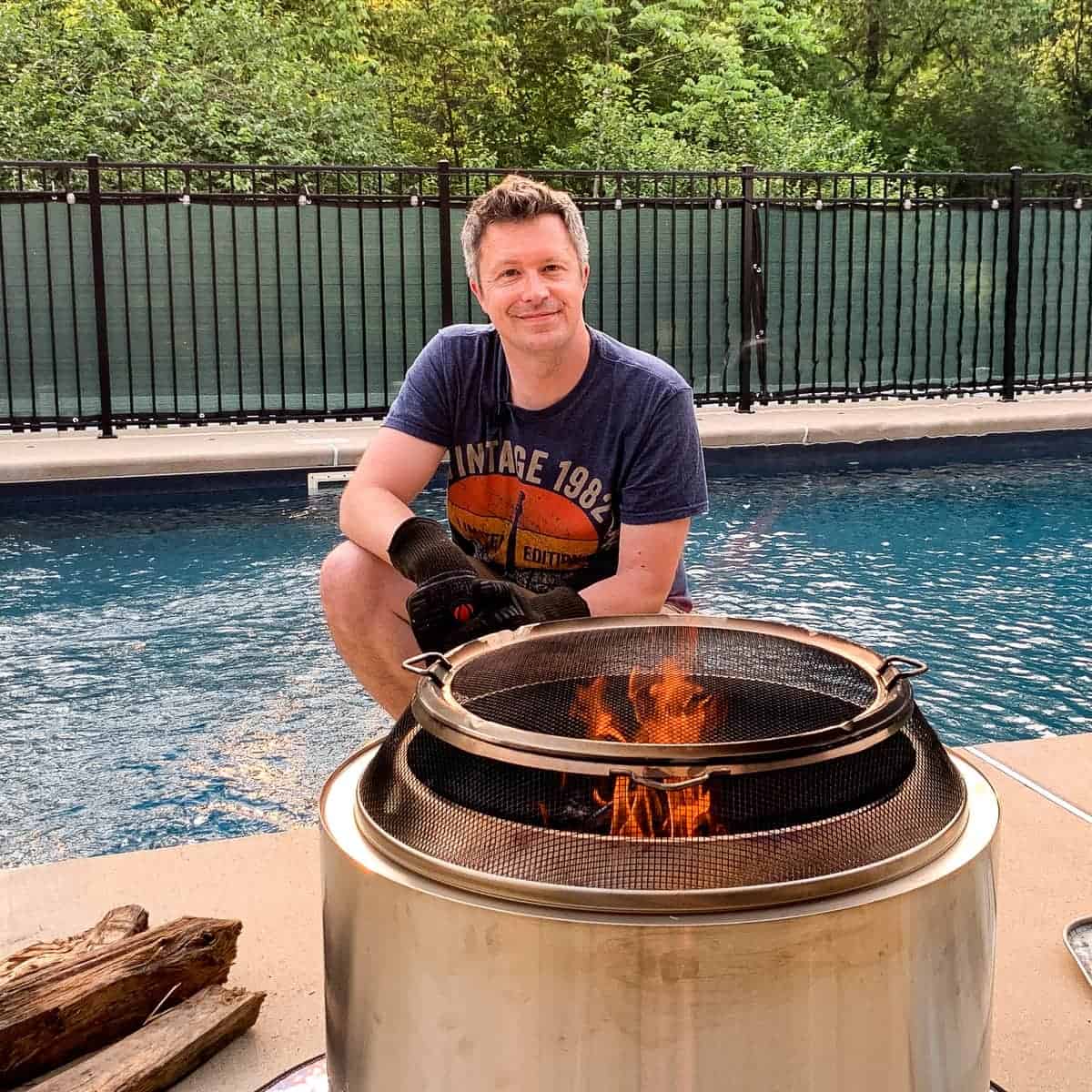 Mads Martigan by a pool behind a solo stove firepit