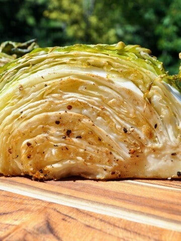 smoked cabbage cut open on a cutting board