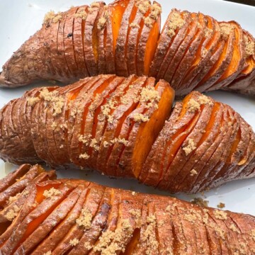 Sticky smoked sweet potatoes on a white plate