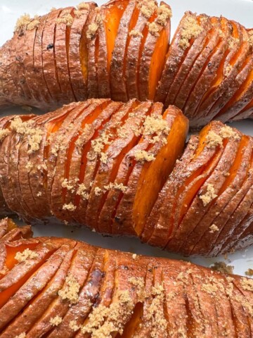 Sticky smoked sweet potatoes on a white plate