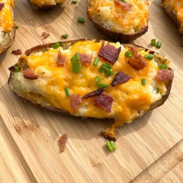 Smoked Twice Baked potatoes on a wooden cutting board