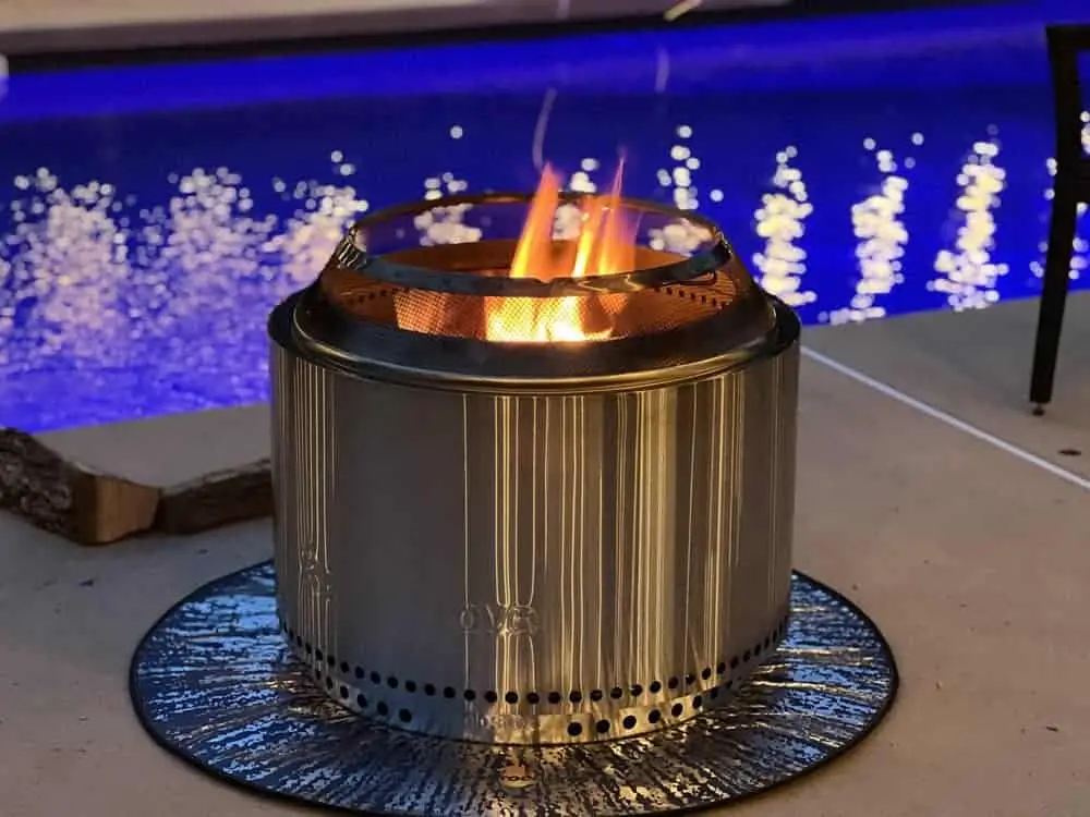 Solo stove burning on concrete by pool