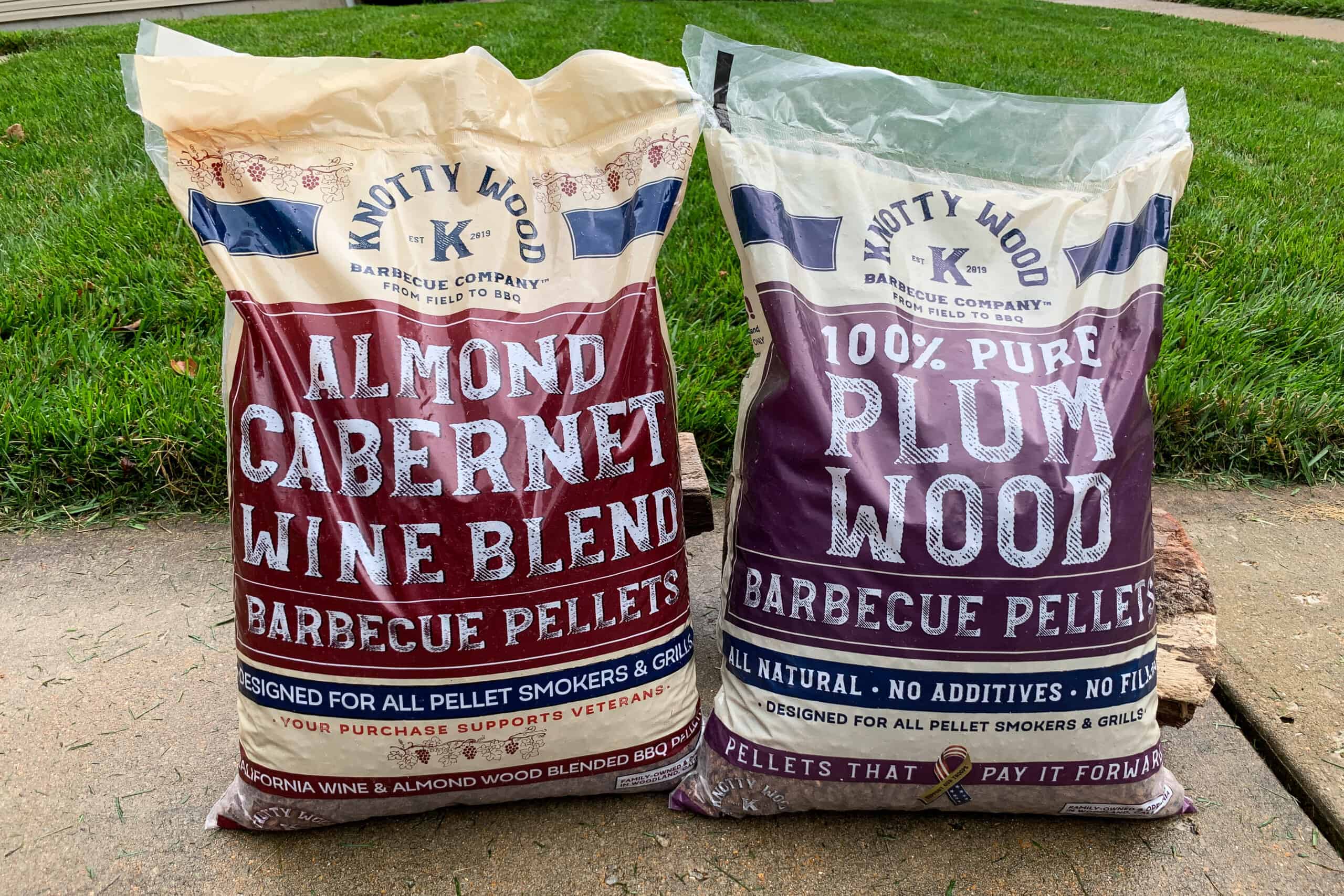 bags of Knotty Wood brand 100% Pure Plum wood pellets on the right and almond cabernet wine blend on the left