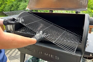 removing the top rack at a diagonal with gloved hands