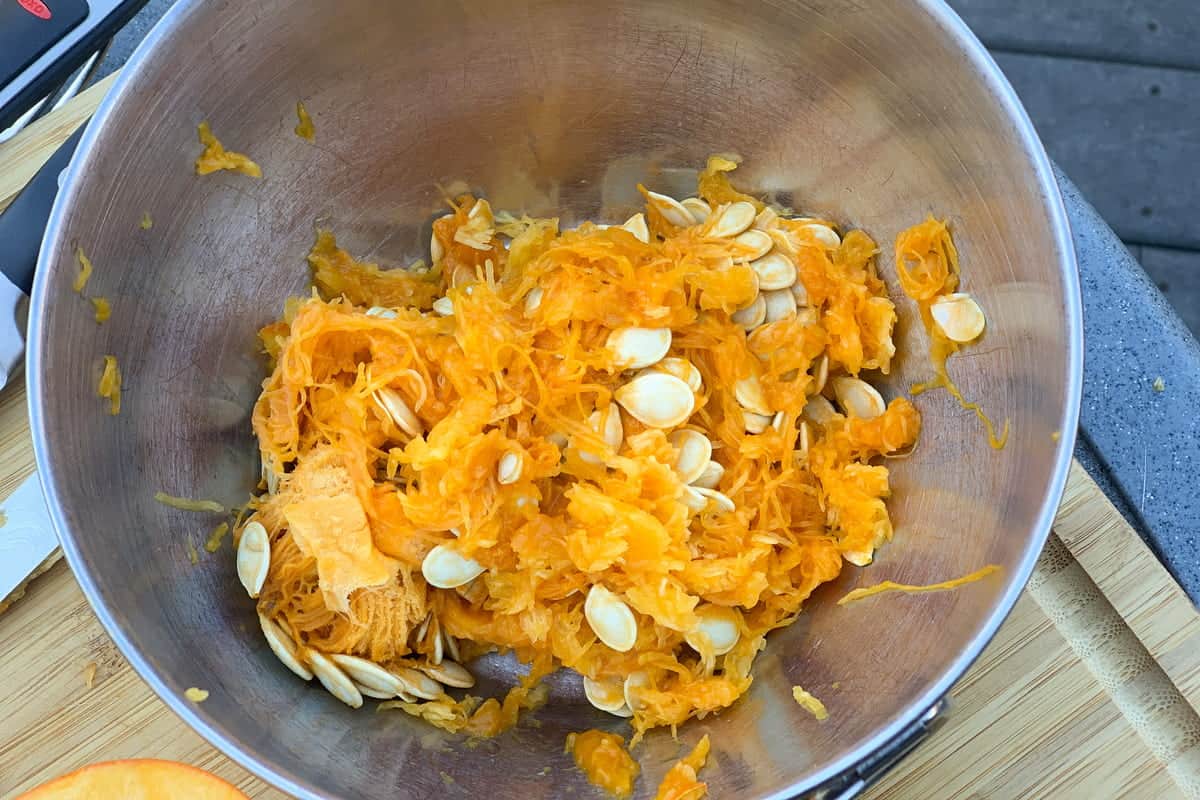 a bowl of pumpkin seeds and pulp