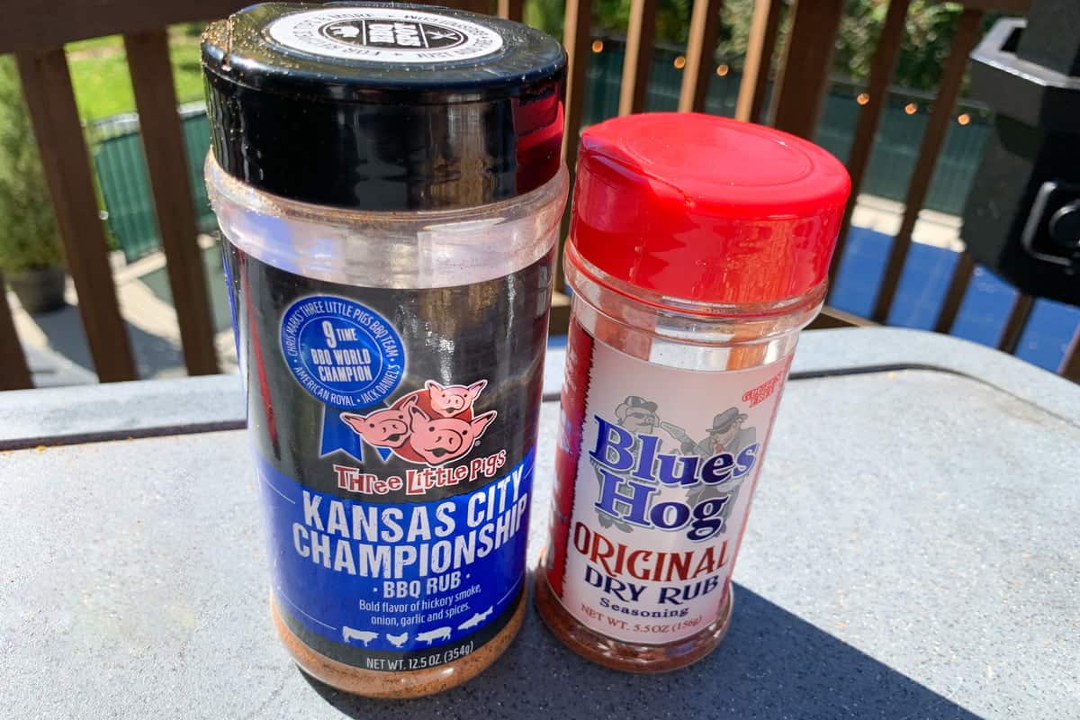 a bottle of Three Little Pigs Championship Blend Rub next a to bottle of Blues Hog BBQ Rub