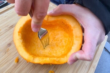 pricking the flesh of a pumpkin with a fork