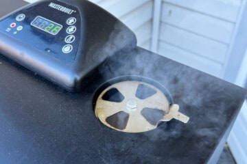 smoke coming out of the top vent of a masterbuilt electric smoker