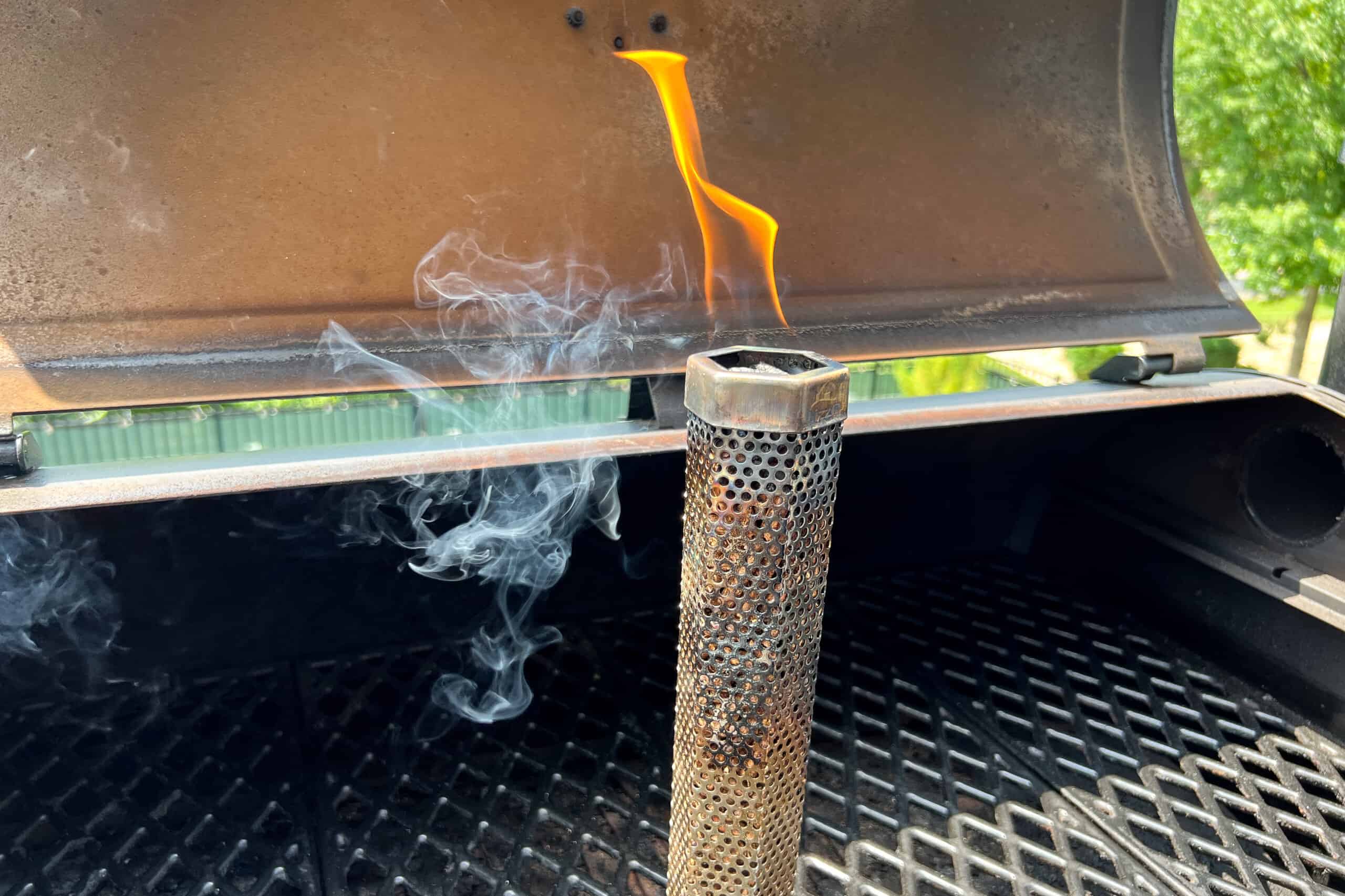 flame coming out of lit pellets at the top of the pellet smoker tube