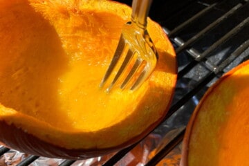 fork going into the flesh of a smoked pie pumpkin