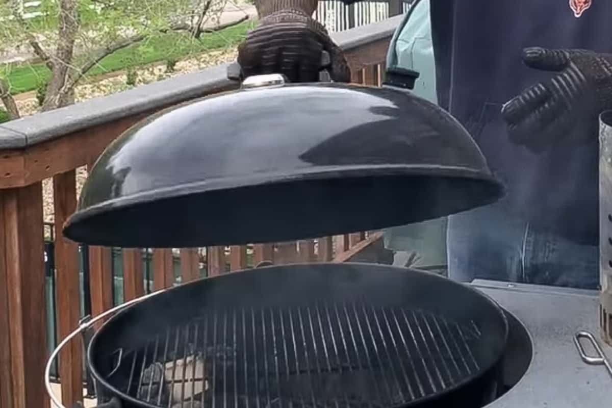 lifting the lid off a charcoal grill