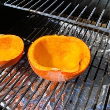 pumpkin smoking on the grates of a Z Grill pellet grill