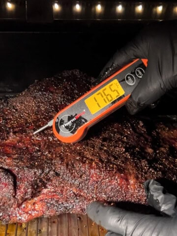 an instant read thermometer in the brisket measuring 176.5 degrees F