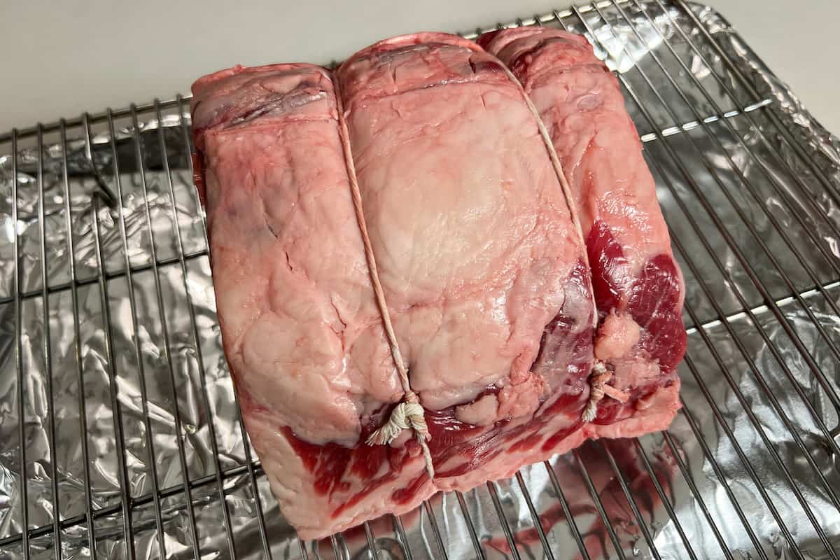 a boneless ribeye roast on a wire rack baking sheet combo