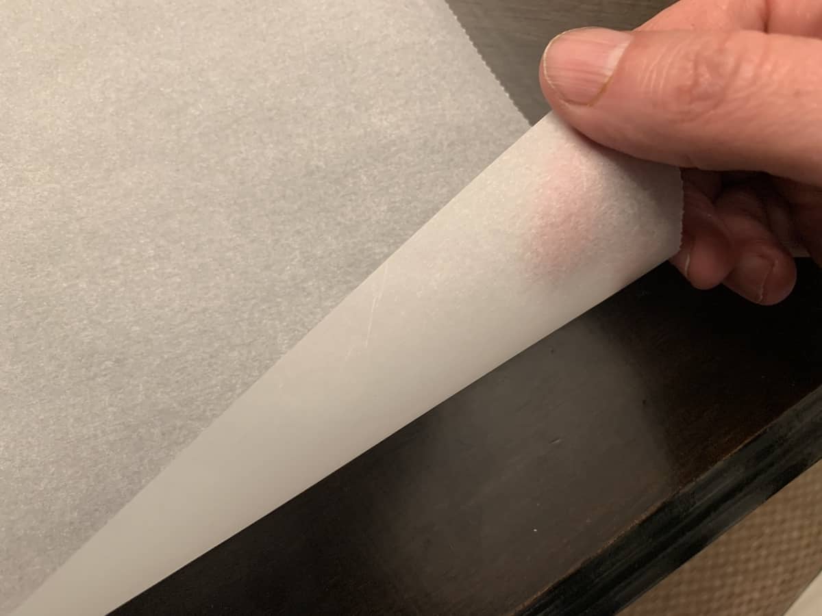 the edge of a piece of parchment paper