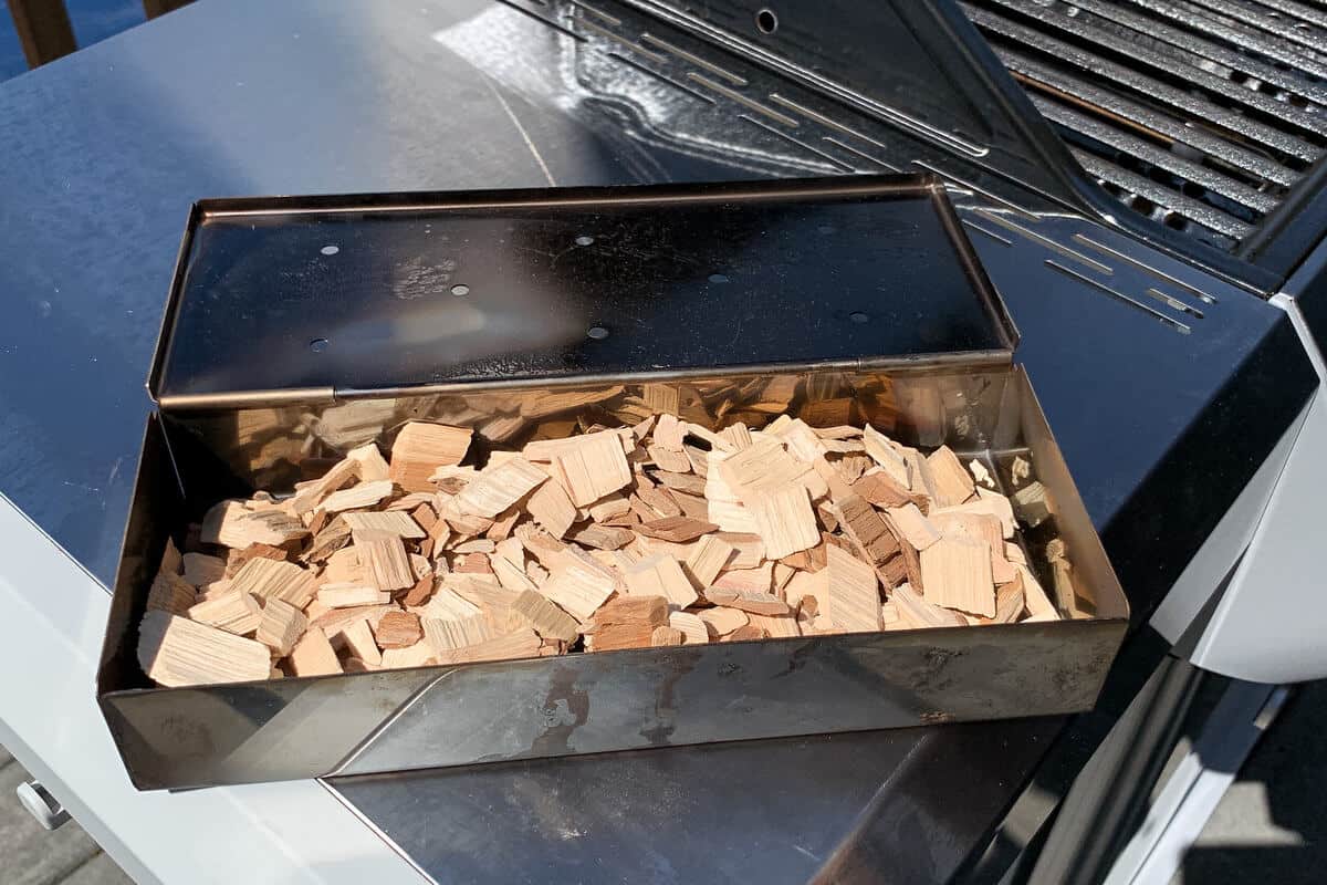 a smoker box filled with pecan wood chips