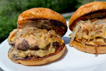smash burgers on a white plate