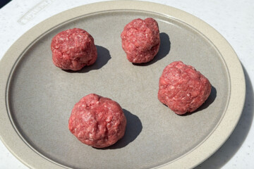 4 balls of hamburger meat on a plate