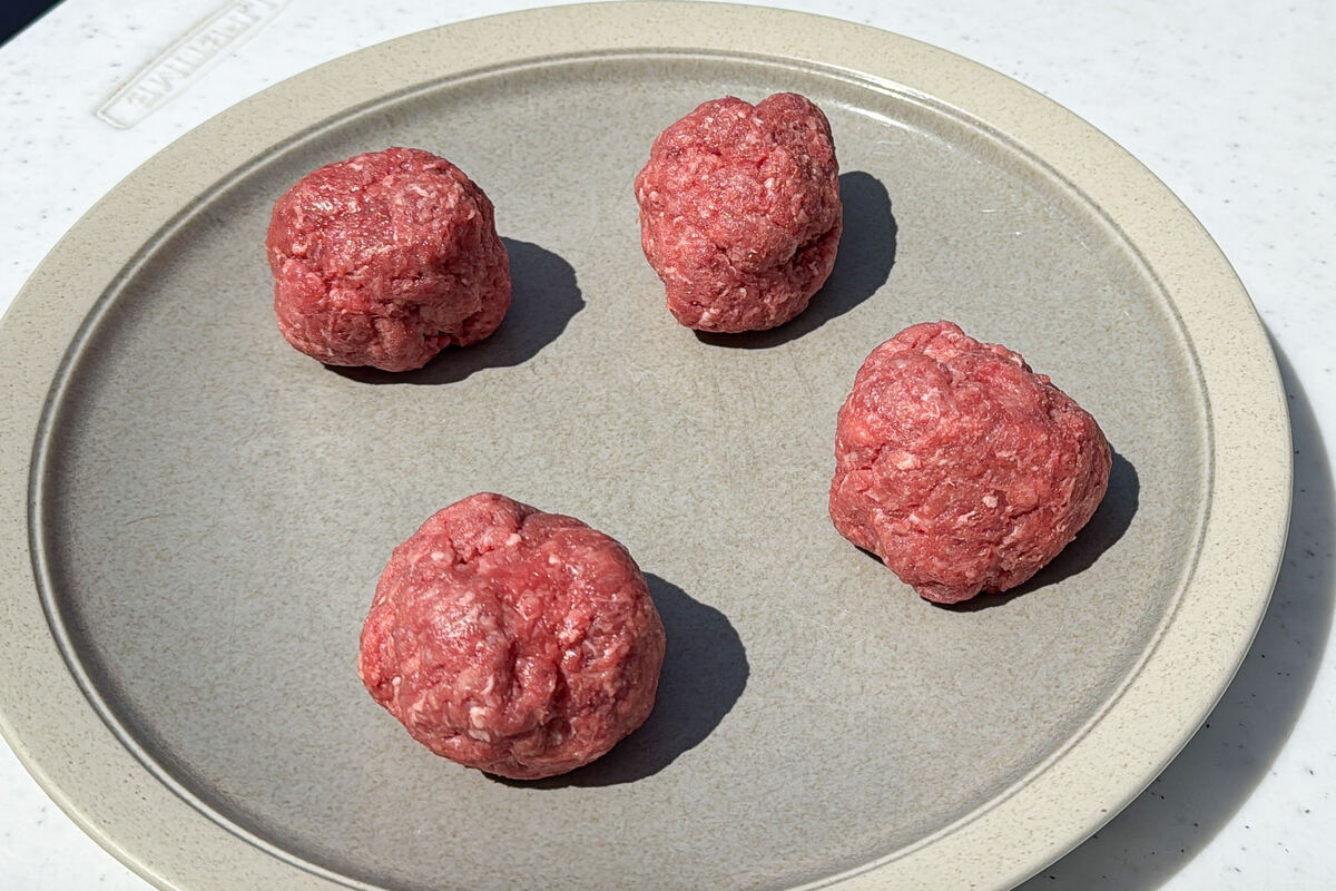 4 balls of hamburger meat on a plate