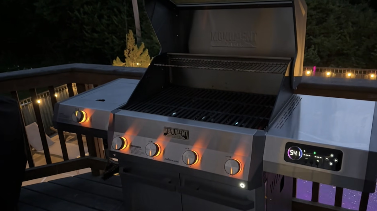 Outdoor gas grill with stainless steel finish and digital temperature control.